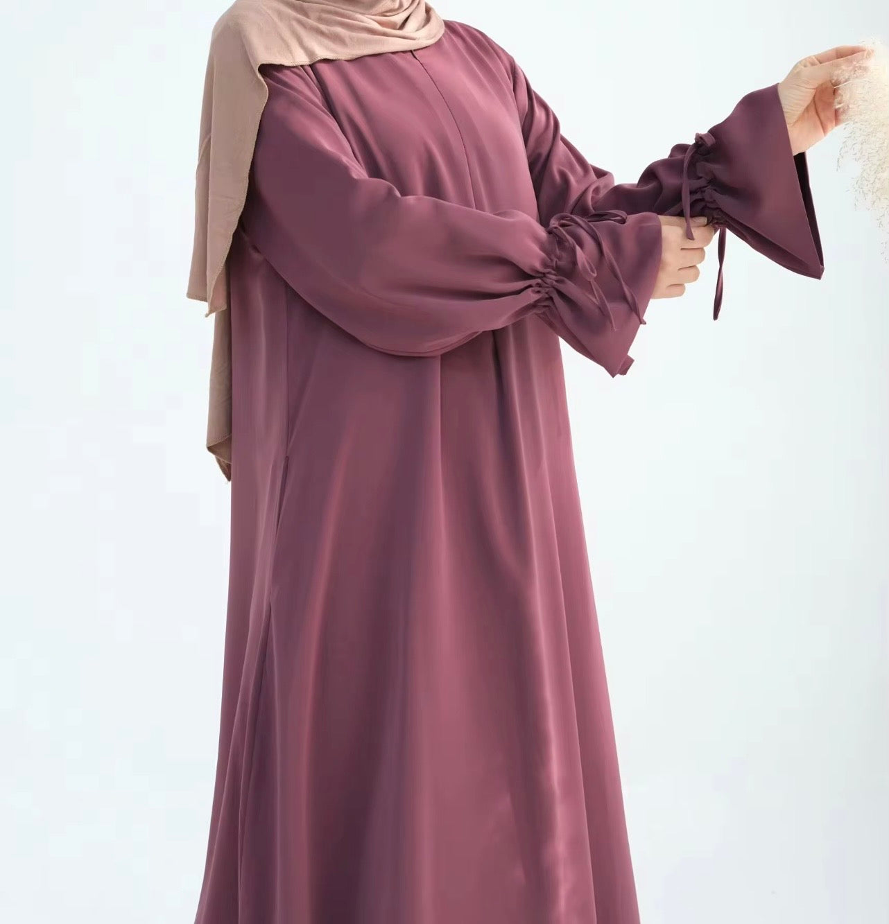 a close up zoom of the nursing friendly abaya with ruffle sleeve and drawstring detailing
