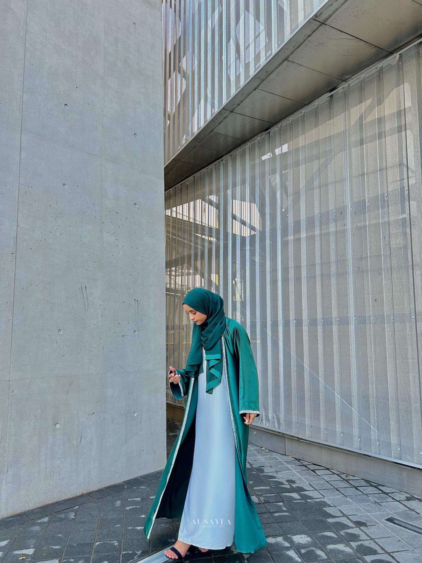 Al-Sayla 4-Piece Satin Abaya Set displayed on a model, featuring an elegant ensemble with matching inner dress, belt, and scarf for a touch of modest luxury.